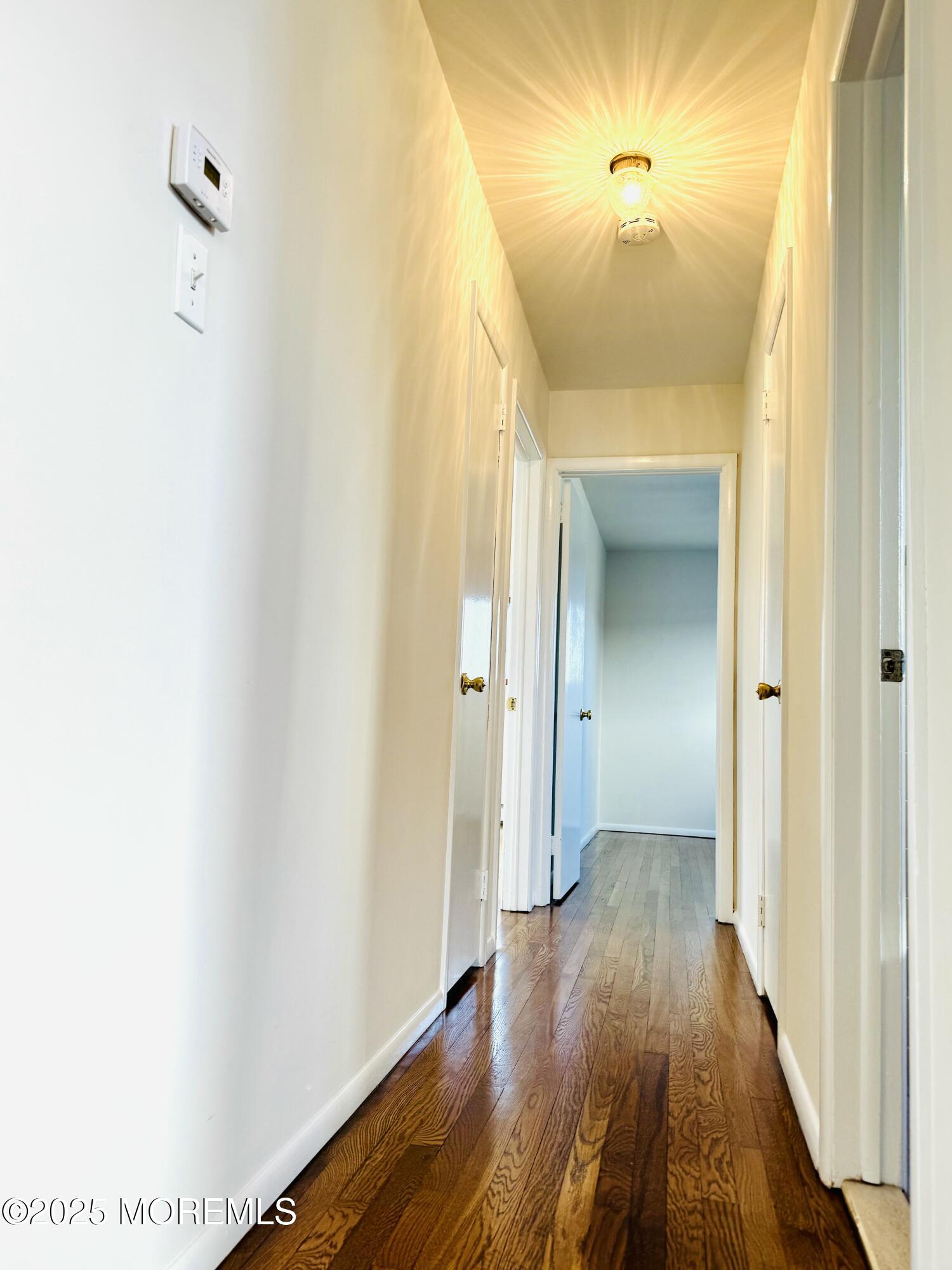 922 Capstan Drive Forked River, NJ 08731 - Photo 8 of 26 a view of a hallway with wooden floor