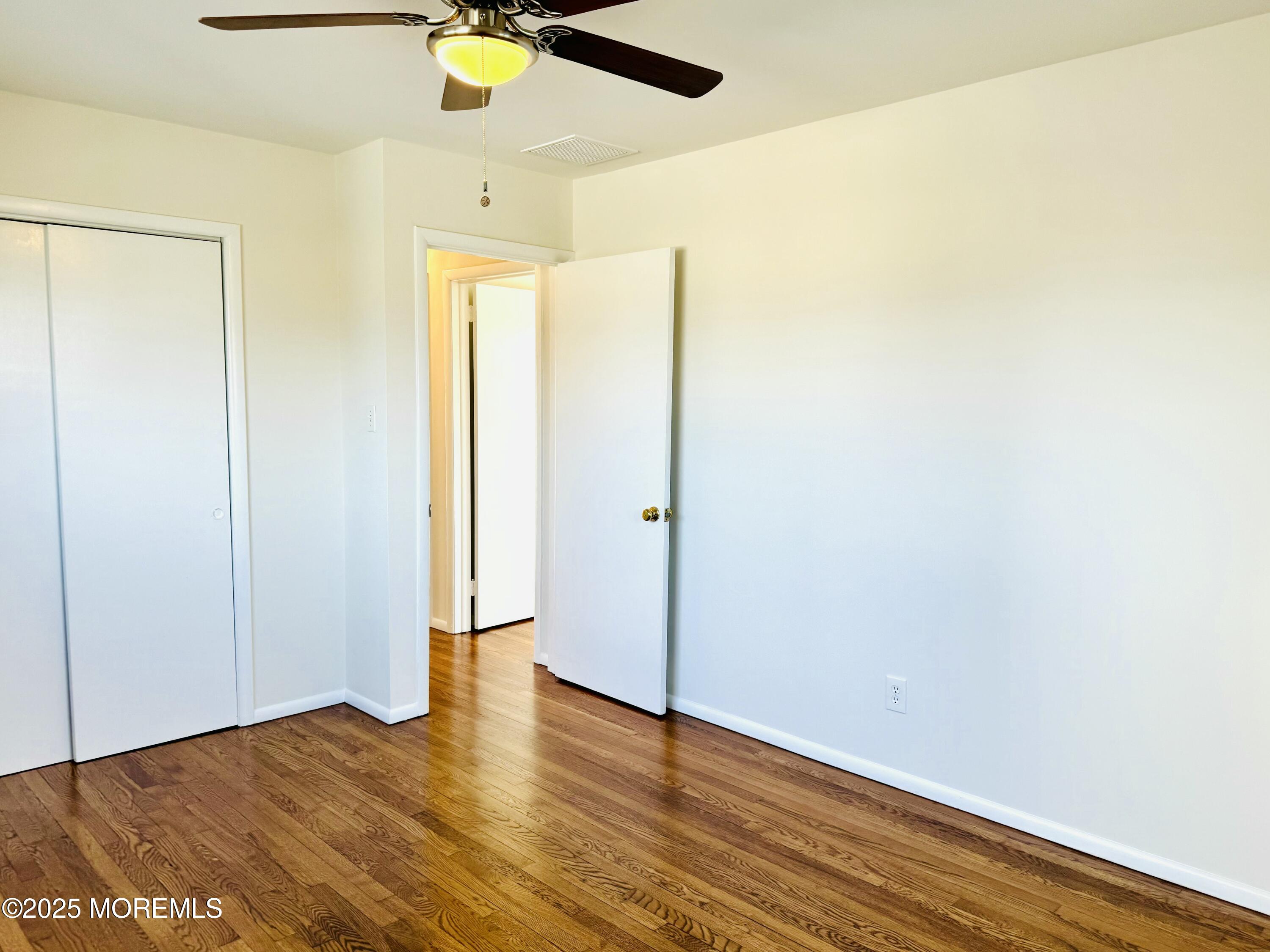922 Capstan Drive Forked River, NJ 08731 - Photo 10 of 26 a view of an empty room with wooden floor