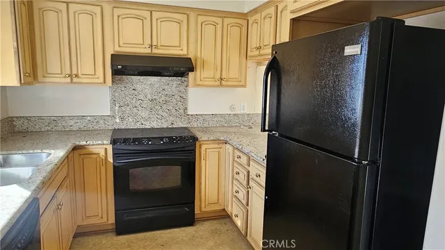 a kitchen with a refrigerator stove and cabinets