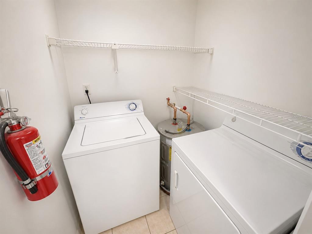 1908 Lake Atriums Circle, Unit 9 Orlando, FL 32839 - Photo 6 of 11 a utility room with dryer and washer
