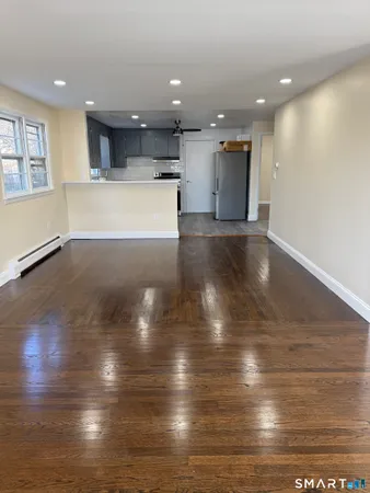 a view of a room with kitchen and a window