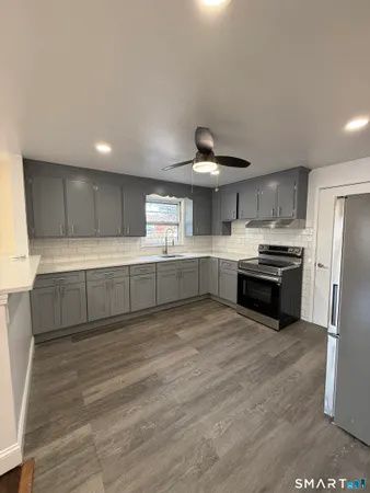 a large kitchen with cabinets and stainless steel appliances