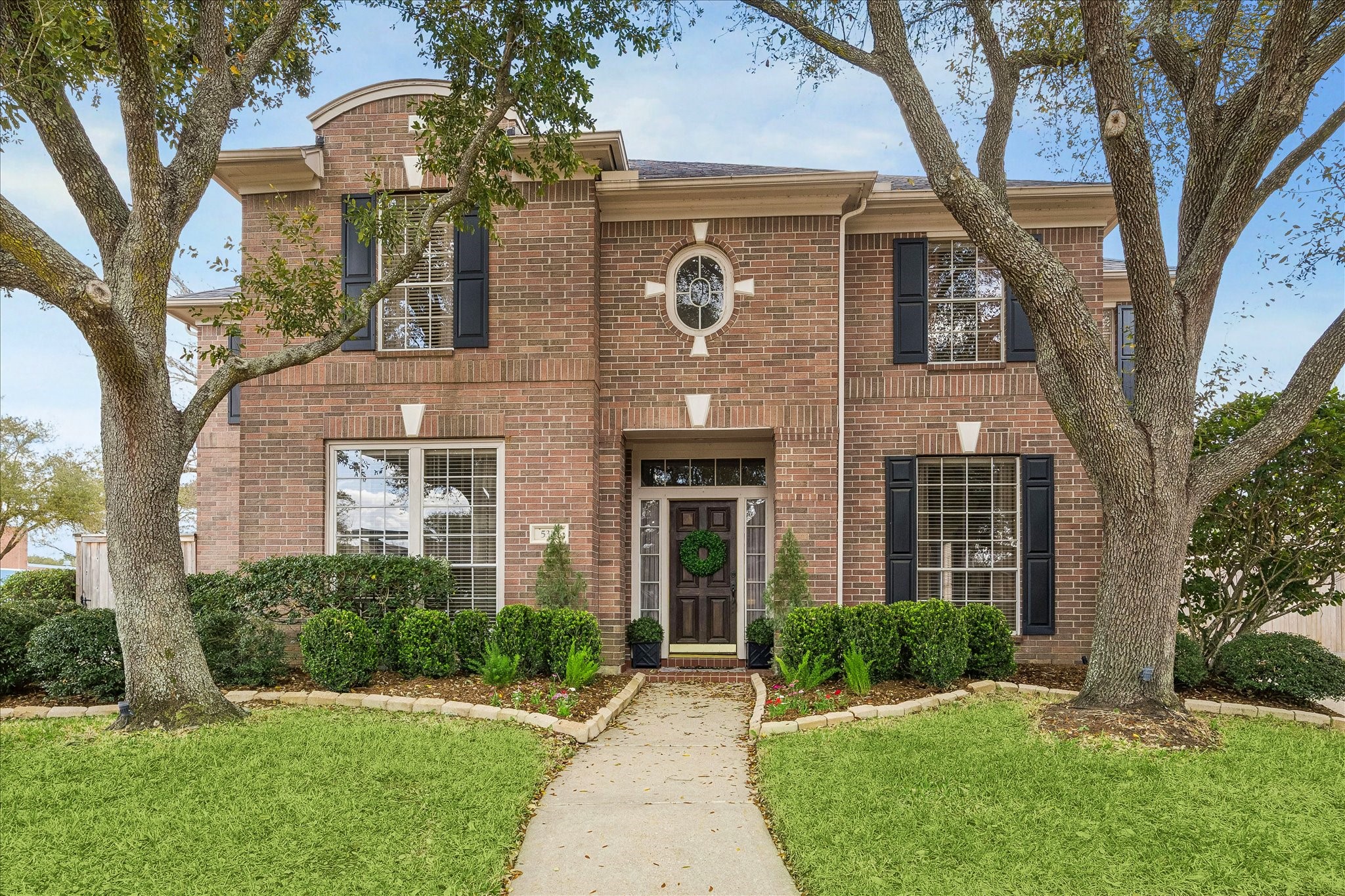 This charming two-story brick home is settled on a cul-de-sac in the gated community of Lakes on Eldridge.