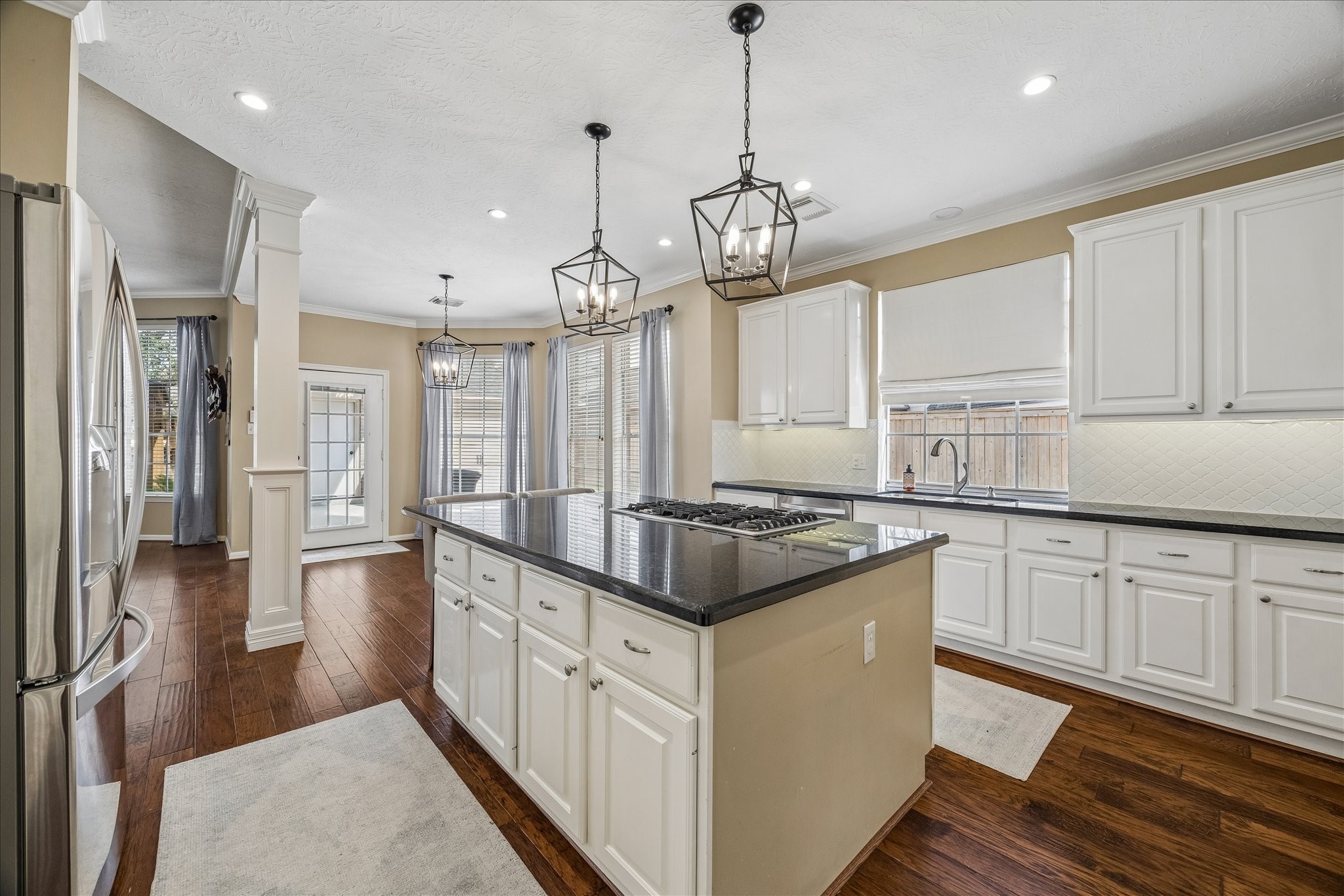 5310 Summerland Ridge Court Houston, TX 77041 - Photo 14 of 46 a kitchen with stainless steel appliances granite countertop stove top oven and cabinets