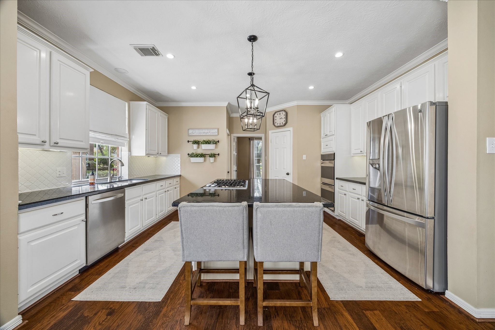 5310 Summerland Ridge Court Houston, TX 77041 - Photo 15 of 46 a kitchen with granite countertop a refrigerator a stove a sink dishwasher a dining table and chairs with wooden floor