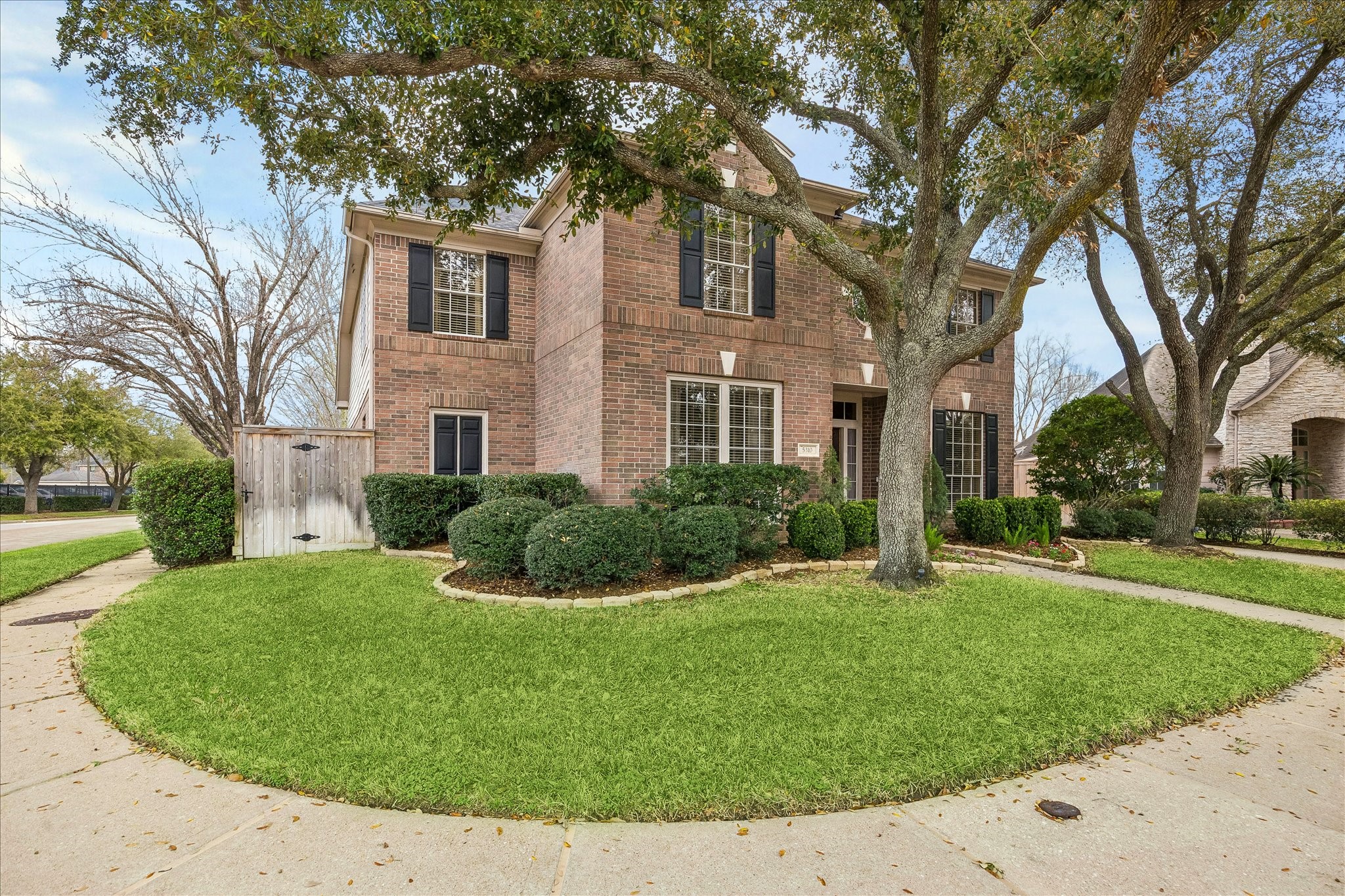 5310 Summerland Ridge Court Houston, TX 77041 - Photo 2 of 46 The house features black shutters, large windows, and a welcoming entrance. Located on a corner lot, it offers a spacious and inviting curb appeal.
