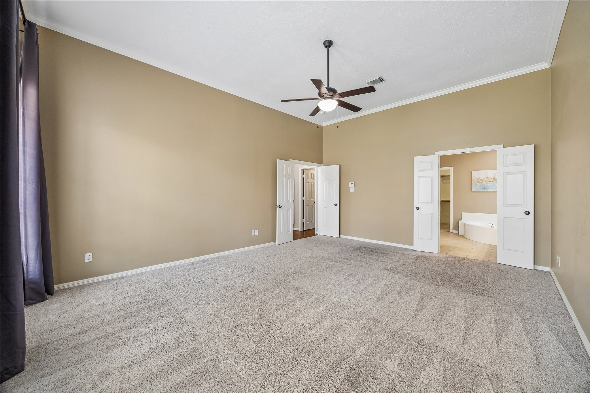 5310 Summerland Ridge Court Houston, TX 77041 - Photo 24 of 46 a view of an empty room with a chandelier fan