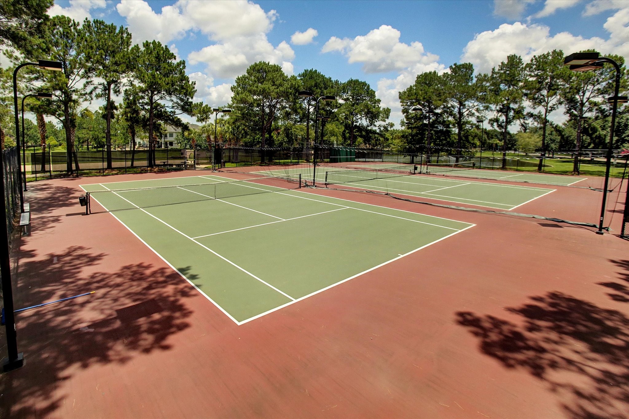 5310 Summerland Ridge Court Houston, TX 77041 - Photo 43 of 46 Lakes on Eldridge offers outdoor tennis court area surrounded by lush greenery and trees, offering a great recreational space for residents.