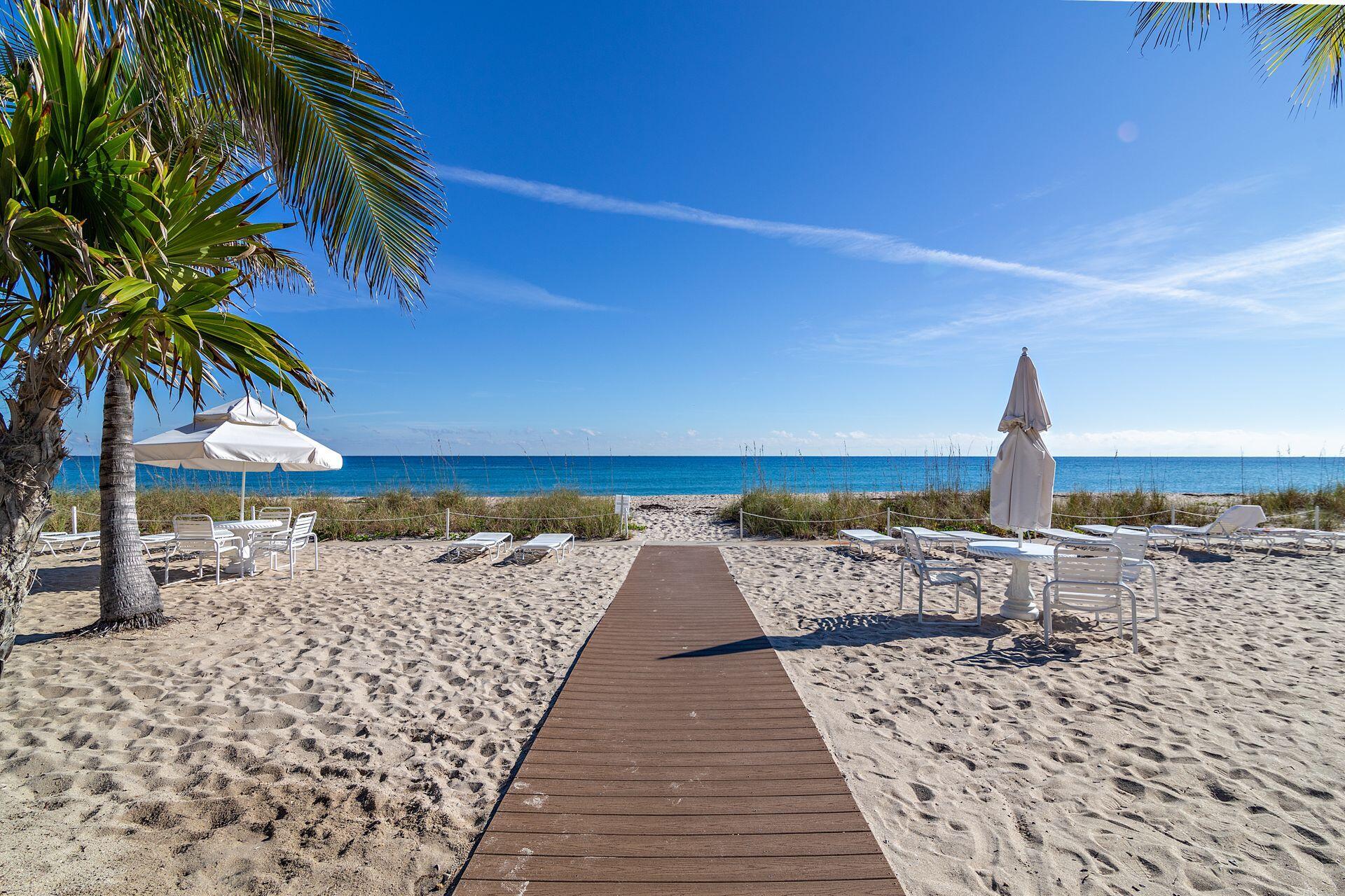 170 North Ocean Boulevard, Unit 409 Palm Beach, FL 33480 - Photo 22 of 34 a view of a roof with wooden floor and a yard