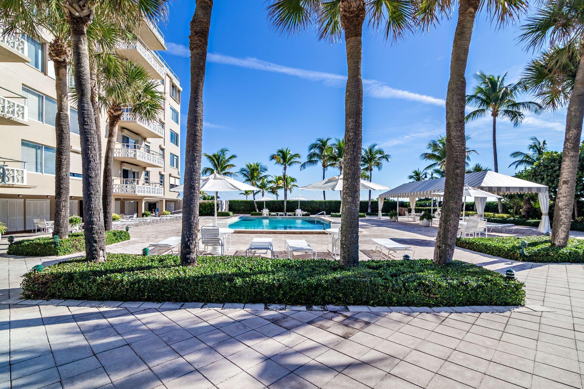 170 North Ocean Boulevard, Unit 409 Palm Beach, FL 33480 - Photo 23 of 34 a front view of a building with a garden
