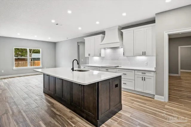 a kitchen with a sink stove and cabinets