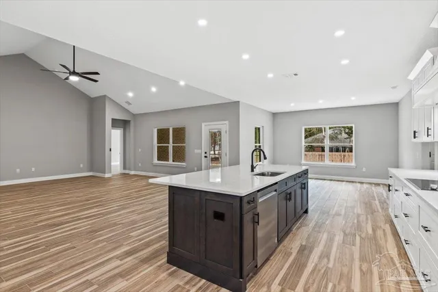 a kitchen with a sink stove and cabinets