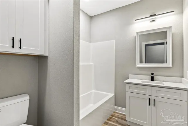 a bathroom with a sink a toilet and a bathtub