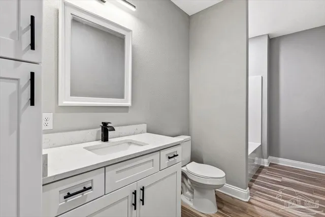a bathroom with a sink toilet and vanity