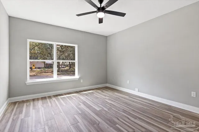 wooden floor in an empty room with a window