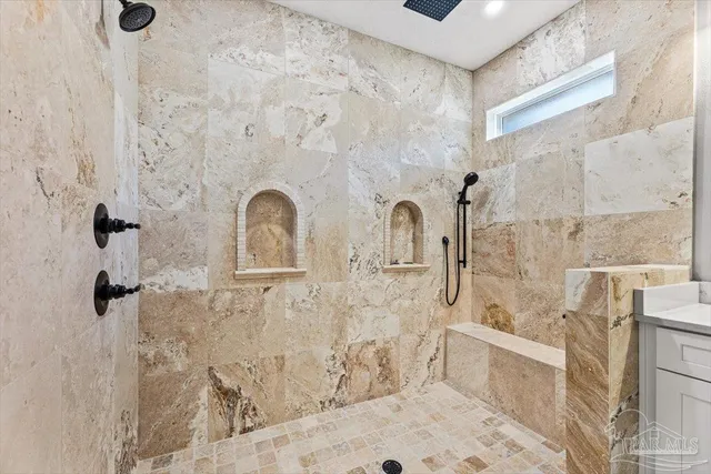 a bathroom with a double vanity sink a mirror a shower and vanity