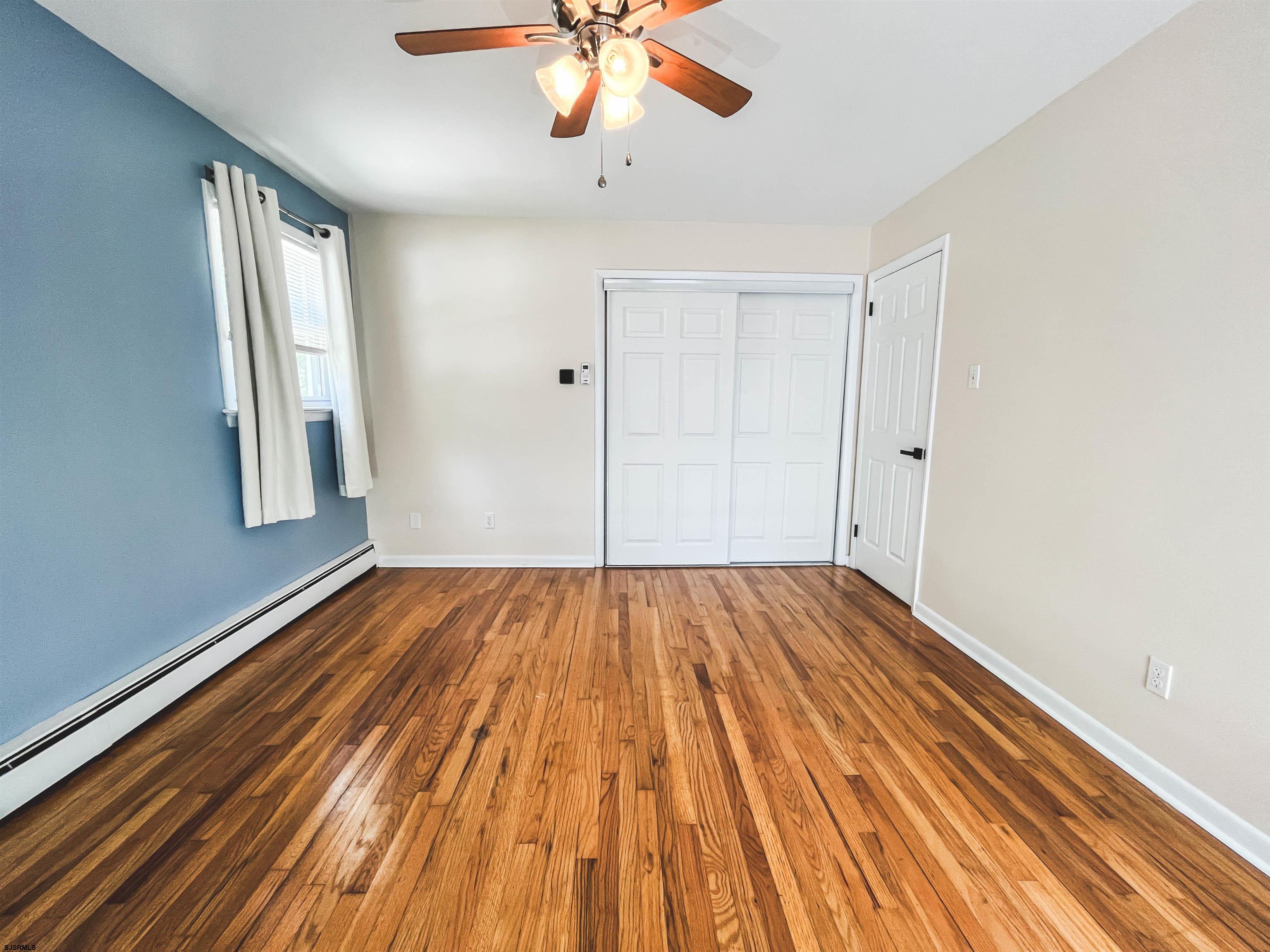 518 Delaware Avenue Absecon, NJ 08201 - Photo 18 of 38 wooden floor in an empty room with a window