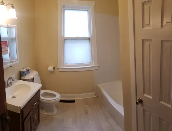 a bathroom with a sink a toilet and tub