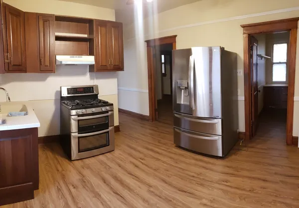 a kitchen with stainless steel appliances a refrigerator and cabinets