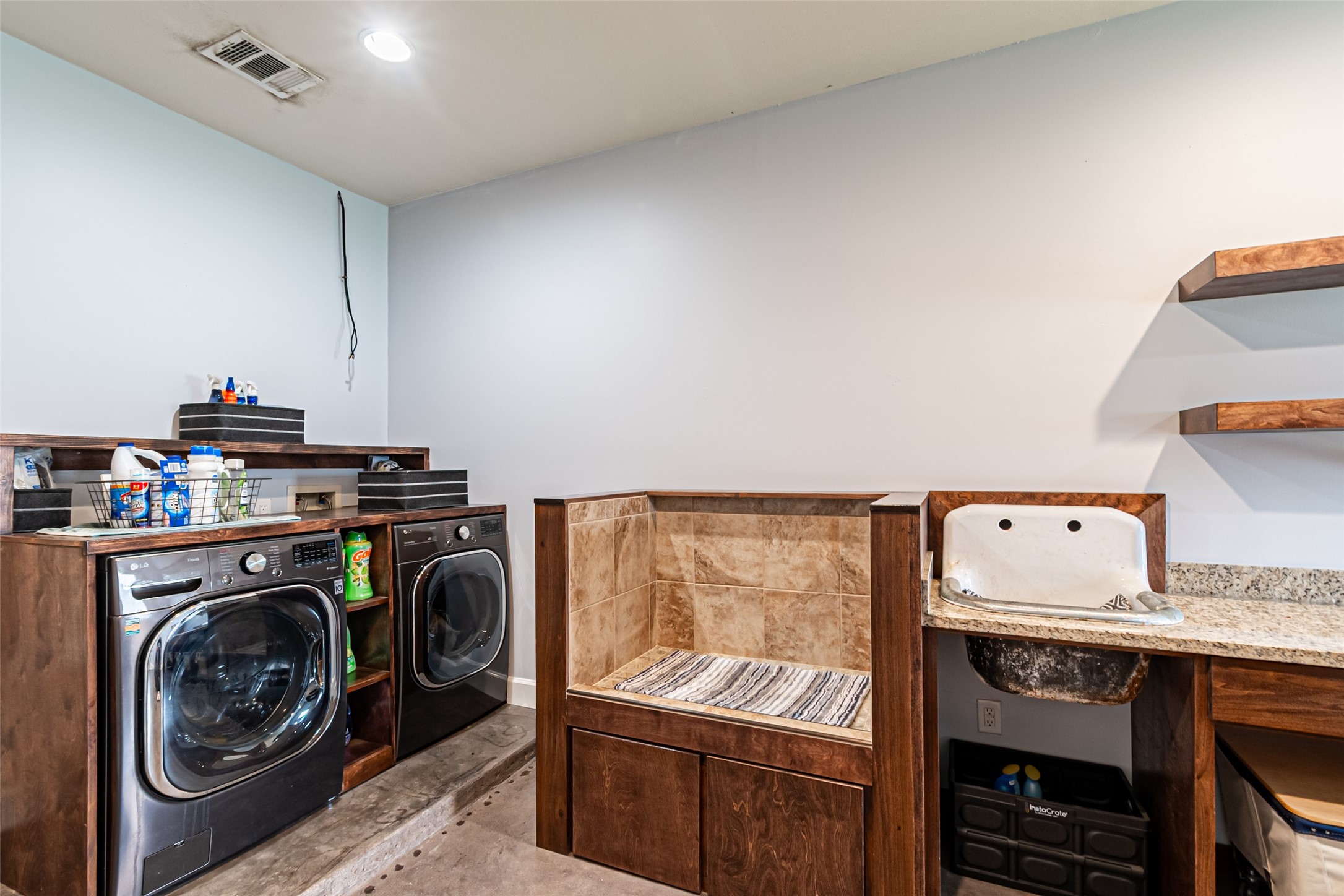 38766 Wyatt Chapel Road Hempstead, TX 77445 - Photo 24 of 45 Spacious laundry room with ample countertop space, and built-in shelving. The room features a utility sink and a tiled pet washing station, making it functional and versatile.