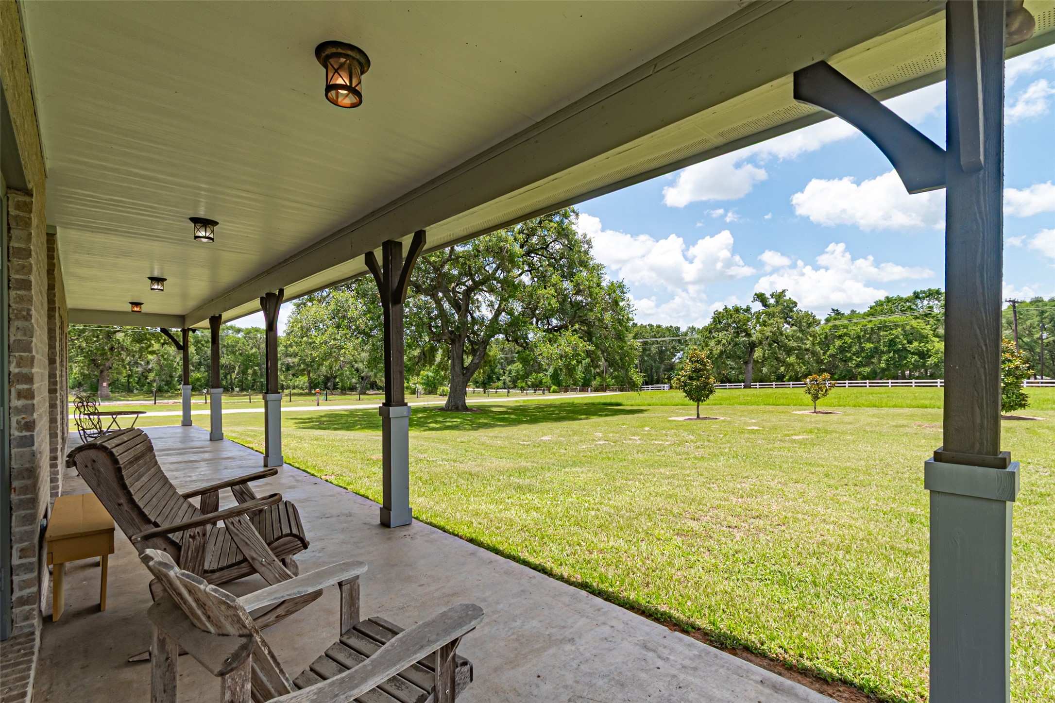 38766 Wyatt Chapel Road Hempstead, TX 77445 - Photo 4 of 45 Spacious front porch, perfect for relaxing and enjoying the serene views of the lush green landscape.