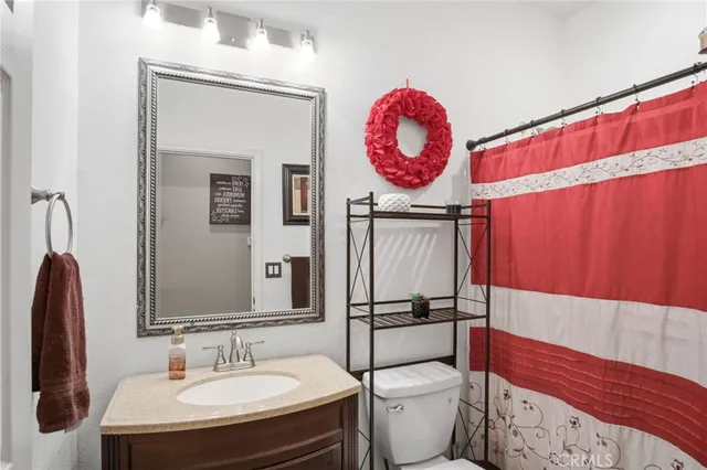 a bathroom with a toilet a sink and a mirror