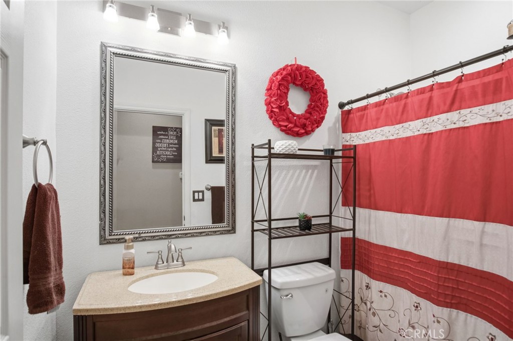 450 Beckman Way Merced, CA 95348 - Photo 12 of 22 a bathroom with a toilet a sink and a mirror