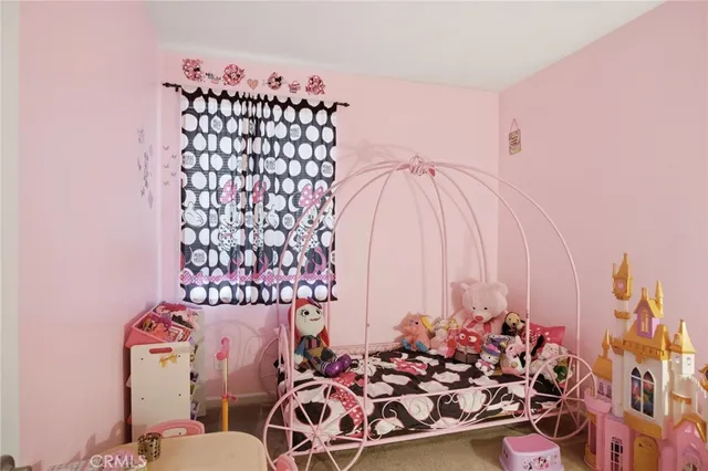 a view of an empty room with window and a chandelier fan