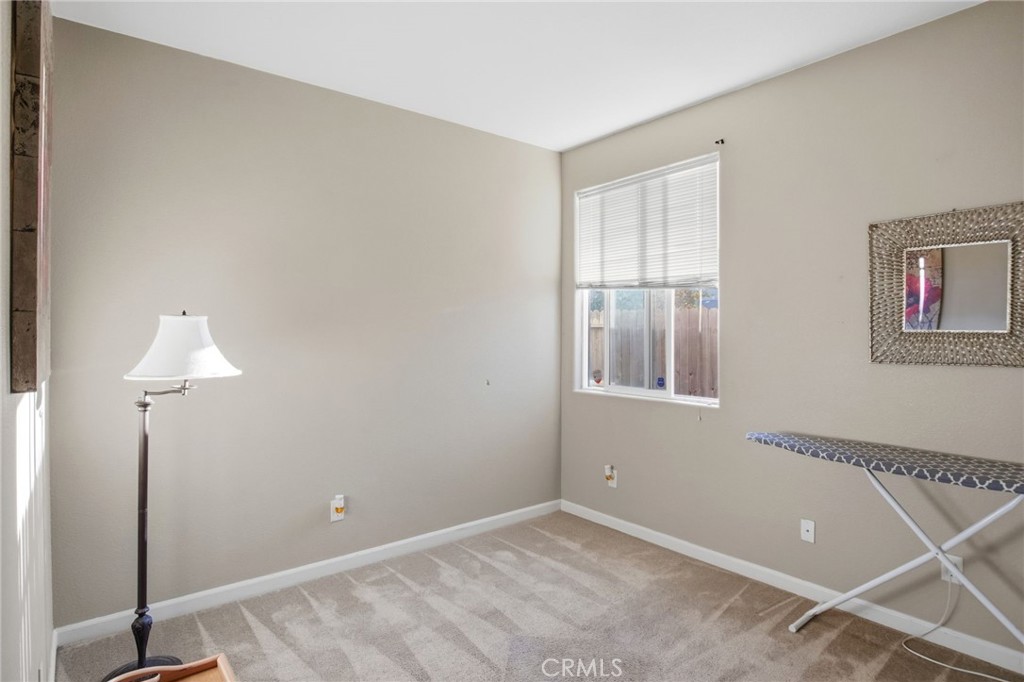 450 Beckman Way Merced, CA 95348 - Photo 16 of 22 a view of an empty room with window and a chandelier fan