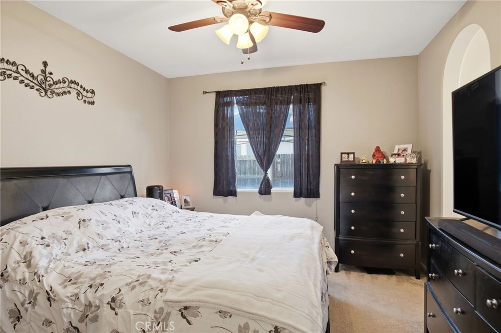 450 Beckman Way Merced, CA 95348 - Photo 17 of 22 a bedroom with a bed and a flat tv screen on dresser