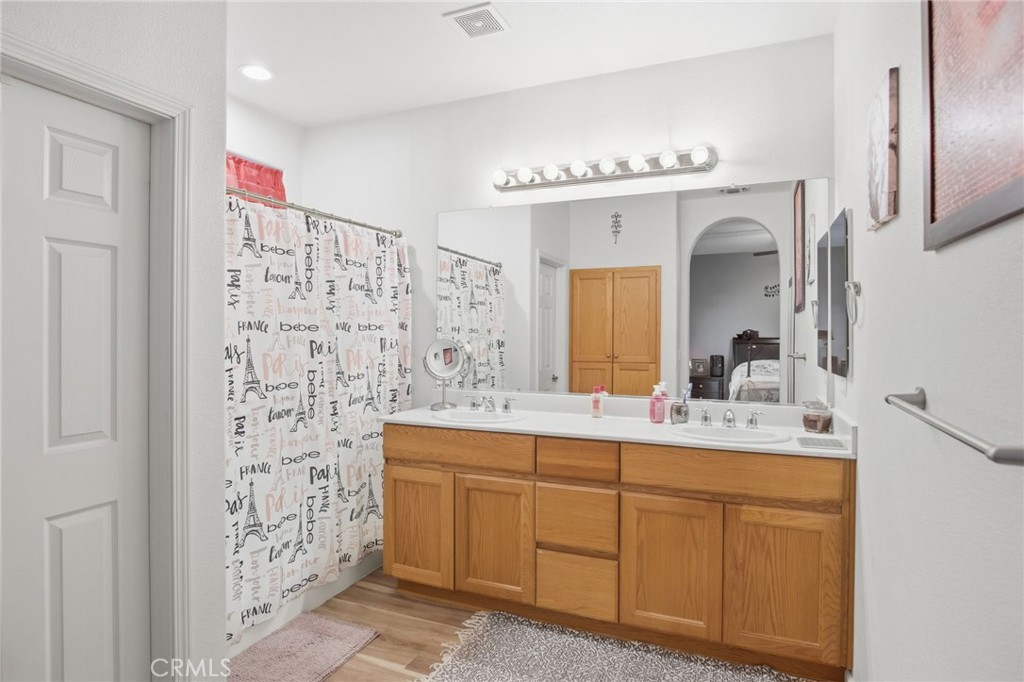 450 Beckman Way Merced, CA 95348 - Photo 19 of 22 a bathroom with a sink a mirror a vanity and a shower