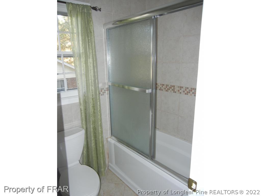 5630 Weatherford Road Fayetteville, NC 28303 - Photo 12 of 16 a bathroom with a shower and a toilet