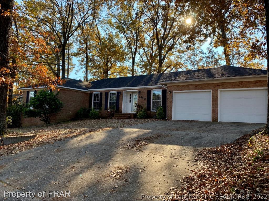5630 Weatherford Road Fayetteville, NC 28303 - Photo 15 of 16 a front view of a house with a yard and trees