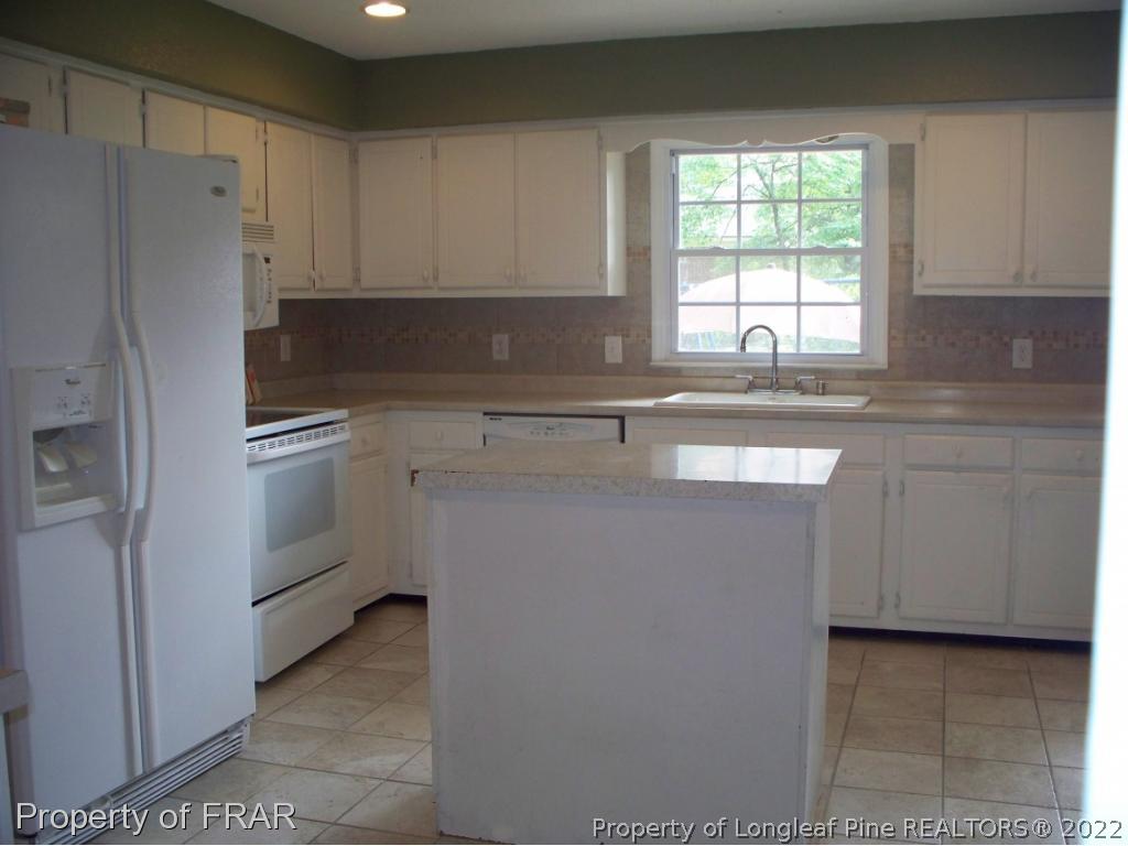 5630 Weatherford Road Fayetteville, NC 28303 - Photo 4 of 16 a kitchen with cabinets appliances a sink and a window