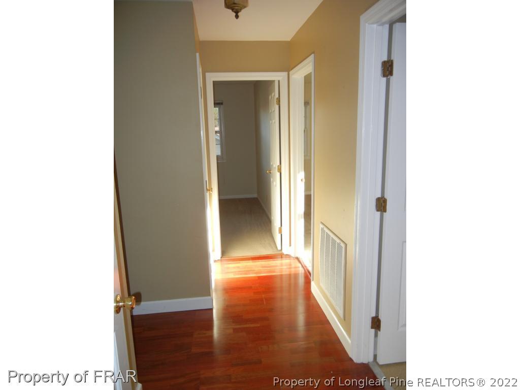 5630 Weatherford Road Fayetteville, NC 28303 - Photo 8 of 16 a view of a hallway with wooden floor