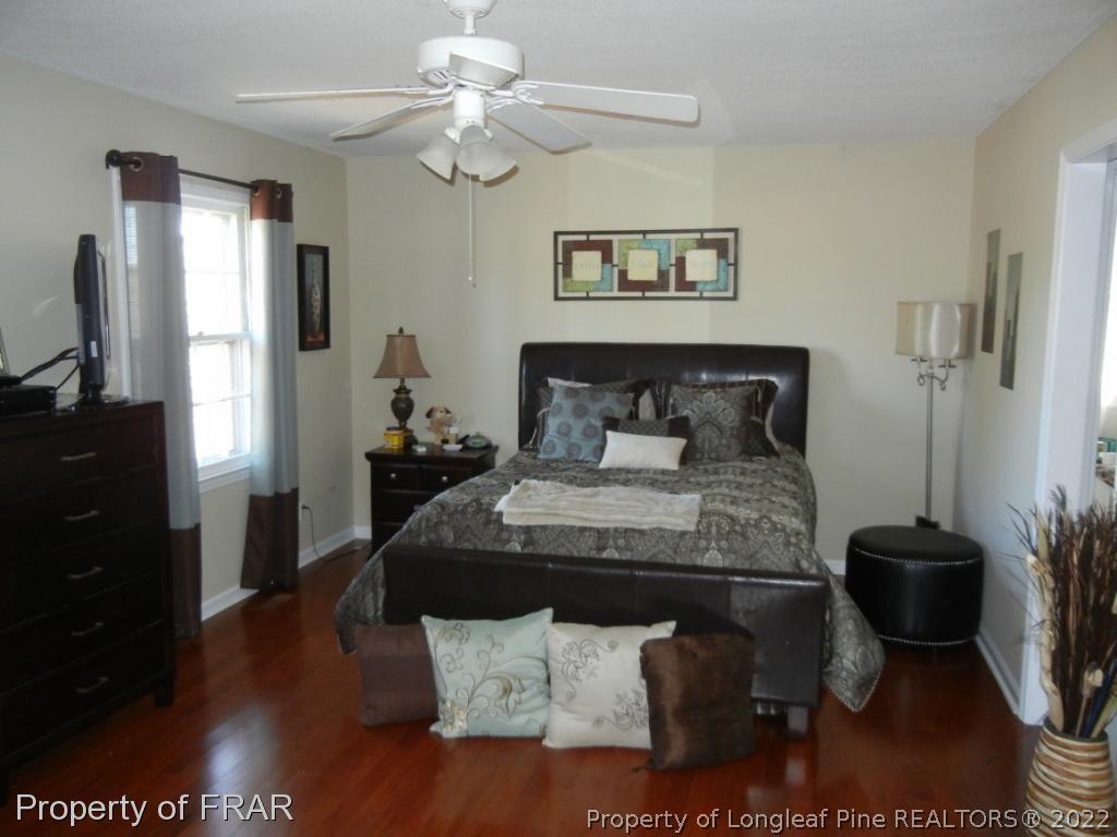 5630 Weatherford Road Fayetteville, NC 28303 - Photo 9 of 16 a bedroom with a bed and a chandelier
