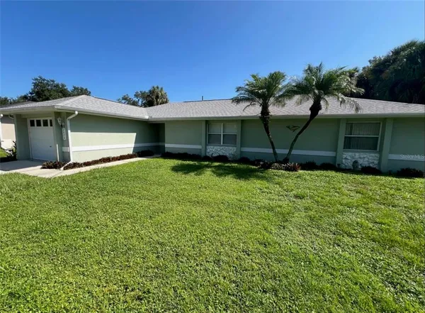 a view of a house with a yard