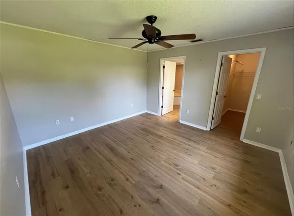 a view of empty room with wooden floor