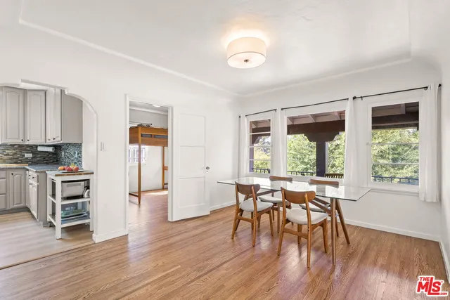 a view of a dining room with furniture and wooden floor