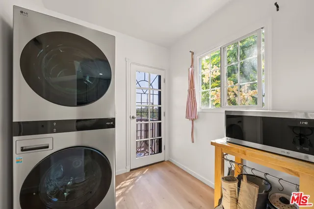 a view of a bedroom with washer and dryer
