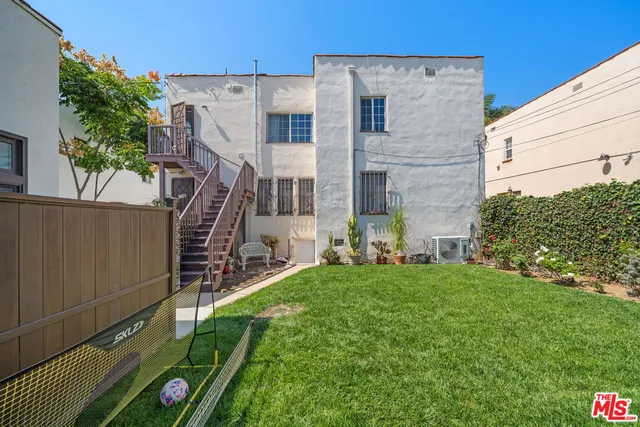 a patio with a table and chairs under an umbrella
