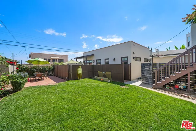 a view of a patio with table and chairs and potted plants