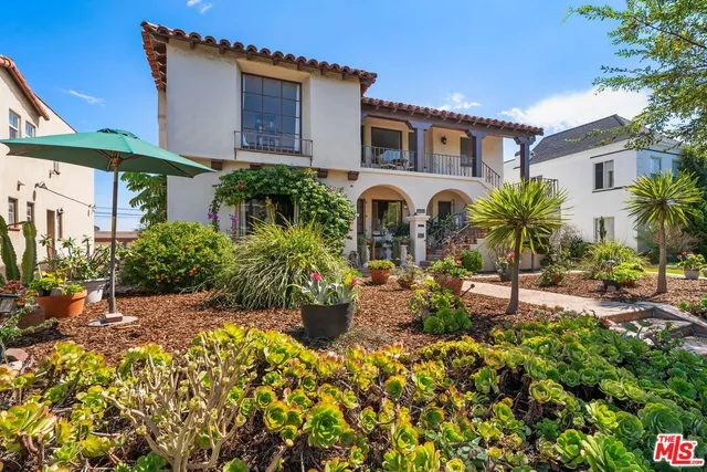 a front view of multiple houses with yard