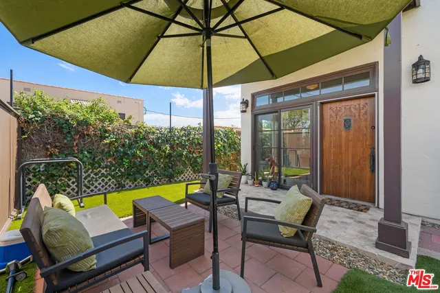 a view of an outdoor sitting area with furniture and umbrella