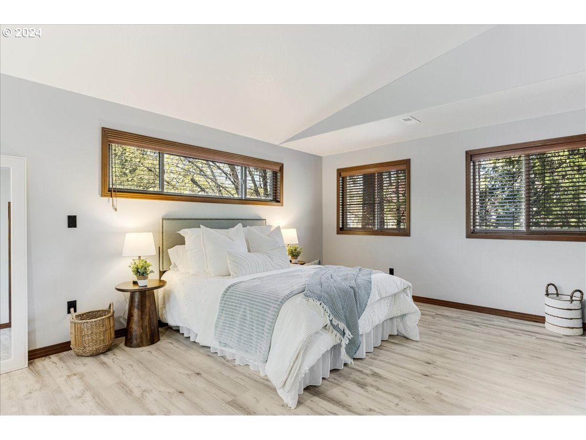 4820 Southwest Marigold Street Portland, OR 97219 - Photo 12 of 34 a bedroom with a bed and a night stand