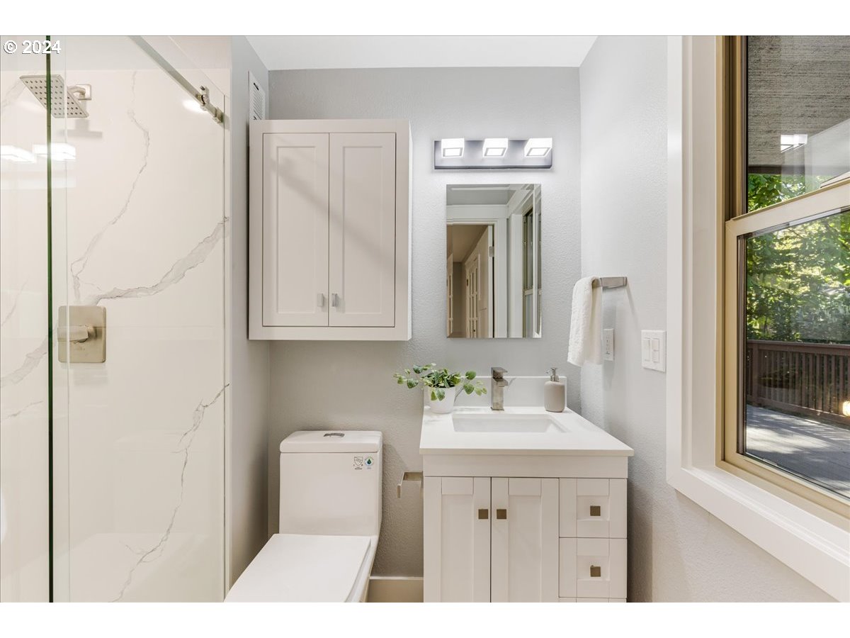 4820 Southwest Marigold Street Portland, OR 97219 - Photo 23 of 34 a bathroom with a sink a toilet and shower