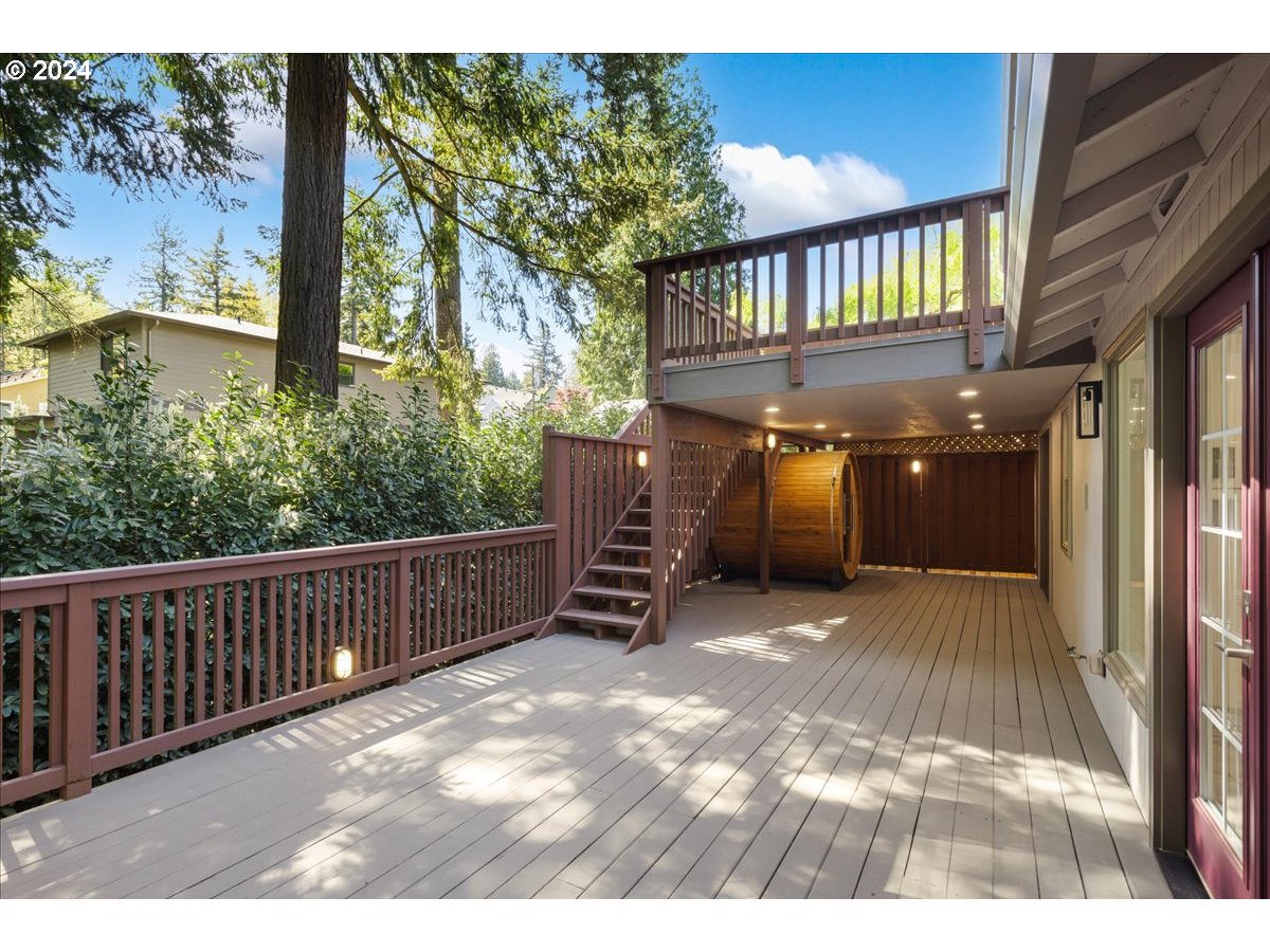 4820 Southwest Marigold Street Portland, OR 97219 - Photo 29 of 34 a view of a porch with wooden stairs and a bench