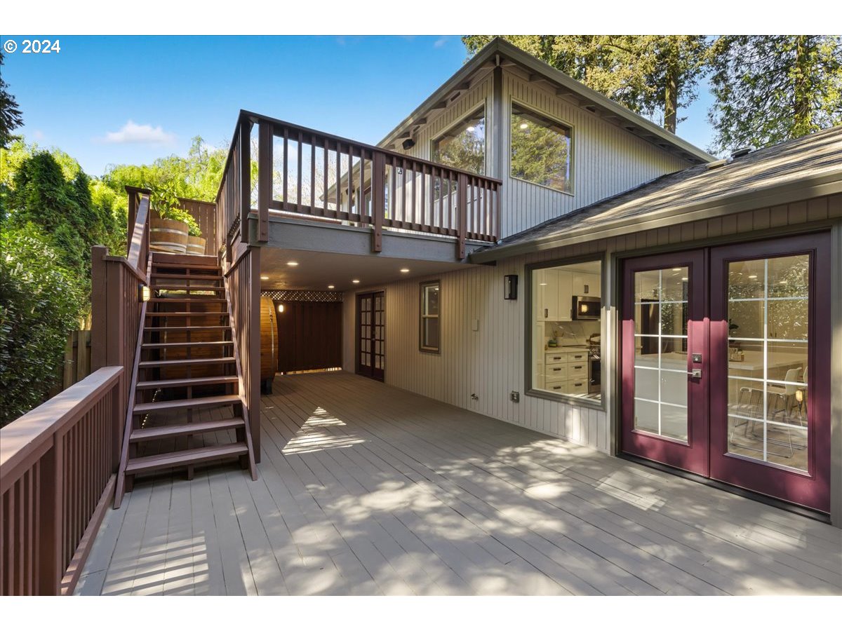 4820 Southwest Marigold Street Portland, OR 97219 - Photo 30 of 34 a view of a house with entrance stairs and a porch