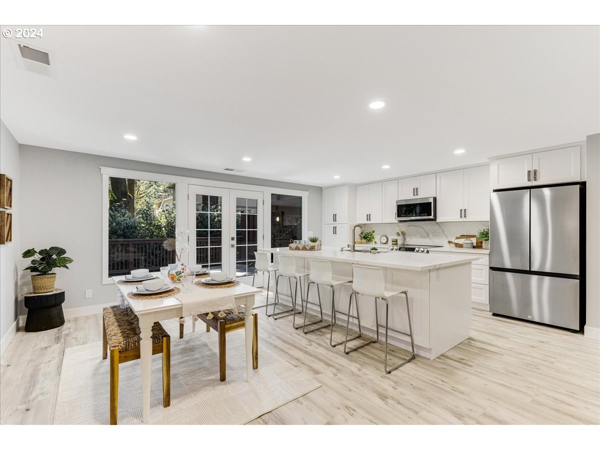 4820 Southwest Marigold Street Portland, OR 97219 - Photo 3 of 34 a living room with stainless steel appliances kitchen island granite countertop furniture and a dining table