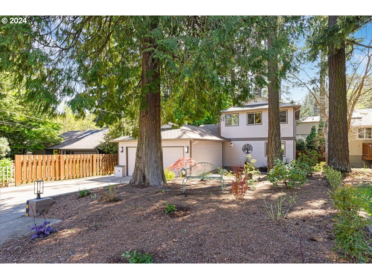 4820 Southwest Marigold Street Portland, OR 97219 - Photo 31 of 34 a backyard of a house with table and chairs